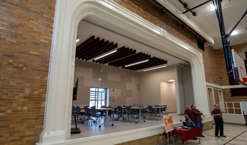 Workers restored the gym's proscenium arch and added a movable wall that allows the stage to serve as additional programming space. PHOTO: Courtesy R. Yoder Construction